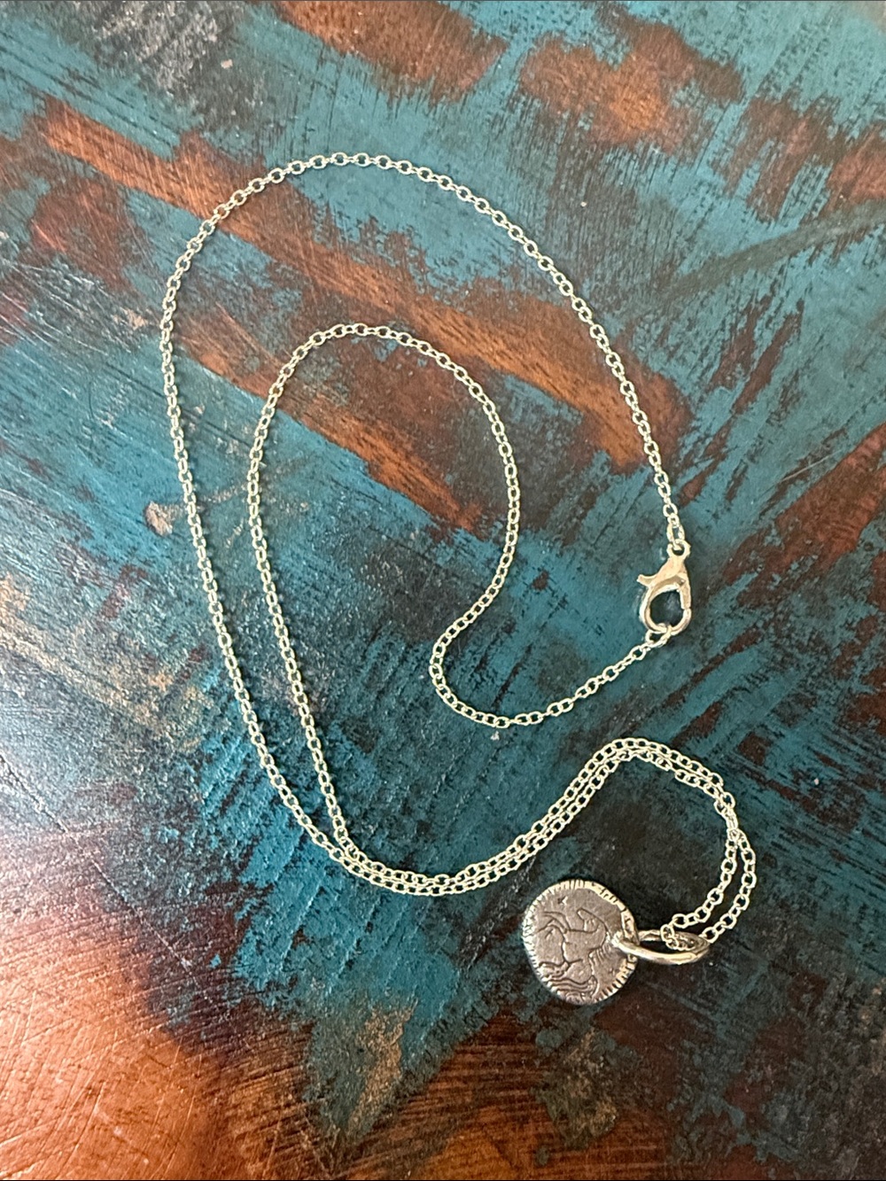 Jes MaHarry unisex “Be Brave” silver horse charm necklace.